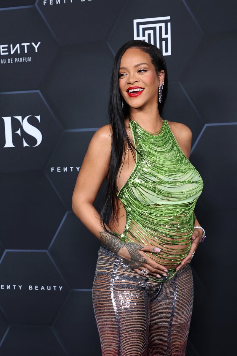For the event, Rihanna wore a green string top by Attico with a pair of coordinated trousers. AFP