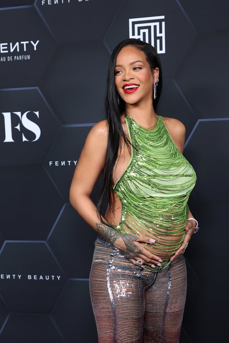 For the event, Rihanna wore a green string top by Attico with a pair of coordinated trousers. AFP