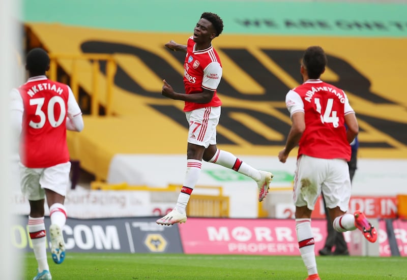 Soccer Football - Premier League - Wolverhampton Wanderers v Arsenal - Molineux Stadium, Wolverhampton, Britain - July 4, 2020 Arsenal's Bukayo Saka celebrates scoring their first goal, as play resumes behind closed doors following the outbreak of the coronavirus disease (COVID-19) Catherine Ivill/Pool via REUTERS  EDITORIAL USE ONLY. No use with unauthorized audio, video, data, fixture lists, club/league logos or "live" services. Online in-match use limited to 75 images, no video emulation. No use in betting, games or single club/league/player publications.  Please contact your account representative for further details.