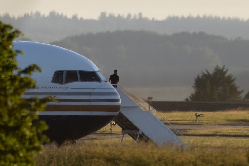 A man stands on the steps of the grounded Rwanda deportation flight EC-LZO Boeing 767 at Boscombe Down Air Base, in June 2022. The flight taking asylum seekers from the UK to Rwanda was grounded at the last minute after the intervention of the European Court of Human Rights