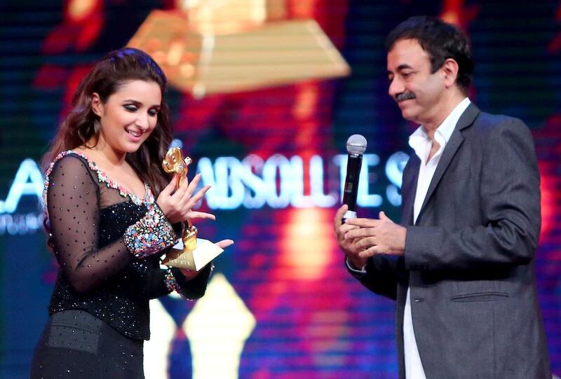 Indian actress Indian actress Parineeti Chopra holds her “Arab Youth Icon Female” award next to Indian film director Rajkumar Hirani. AFP PHOTO / MARWAN NAAMANI