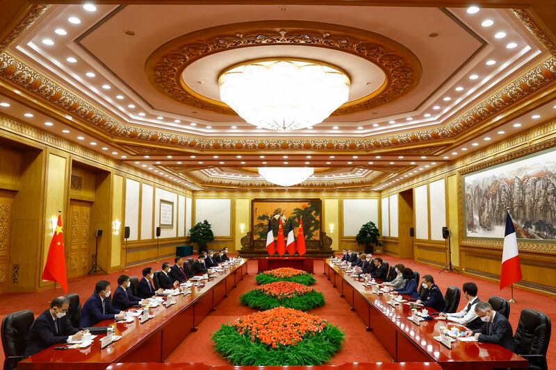 Mr Xi, centre left, and Mr Macron, centre right, at a meeting in the Great Hall of the People in Beijing. AP