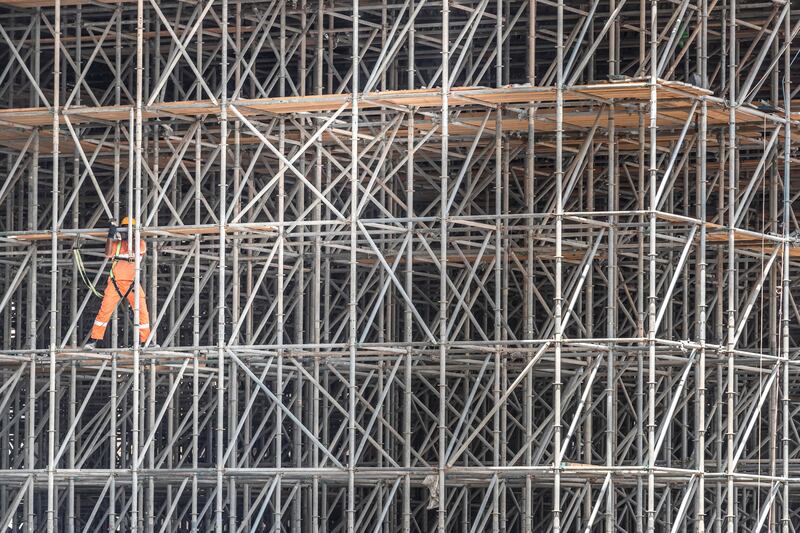 DUBAI, UNITED ARAB EMIRATES. 28 MAY 2018. BIG PICTURE. Infrastructure and building upgrades for Dubai’s push for being ready with the upcoming 2020 Expo. A man climbs through scaffholding on the construction of the new fly over on Sheikh Zayed rd near Al Safa interchange. (Photo: Antonie Robertson/The National) Journalist: None. Section: National.