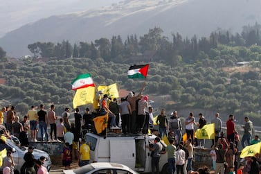 Supporters with Hezbollah, Iran and Palestine flags during an anti-Israel protest in the southern Khiam area by Lebanon's border with Israel. AFP