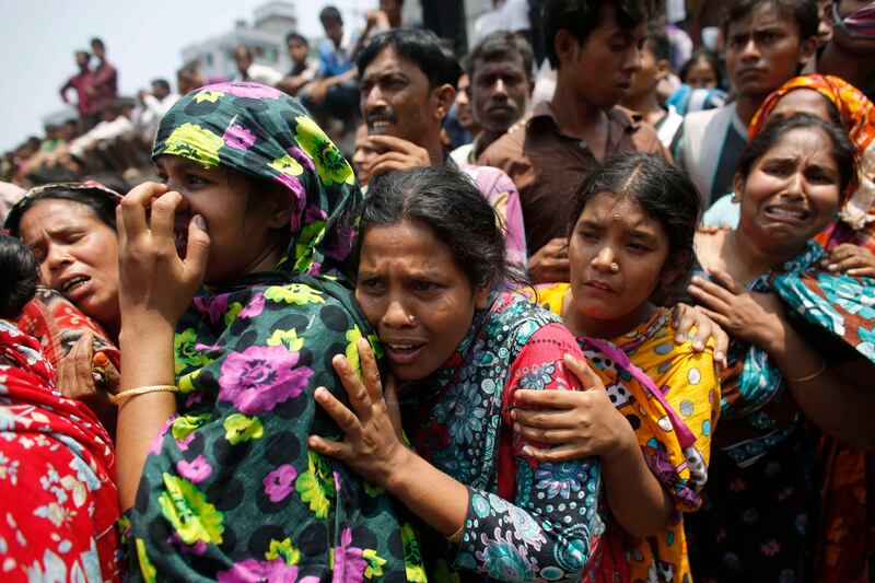 People mourn for their relatives, who are trapped inside the rubble of the collapsed Rana Plaza building, in Savar, 30 km (19 miles) outside Dhaka April 24, 2013. The eight-storey block housing factories and a shopping centre collapsed on the outskirts of the Bangladeshi capital on Wednesday, killing more than 70 people and injuring hundreds, a government official said. REUTERS/Andrew Biraj (BANGLADESH - Tags: DISASTER BUSINESS) *** Local Caption ***  DHA004_BANGLADESH-B_0424_11.JPG