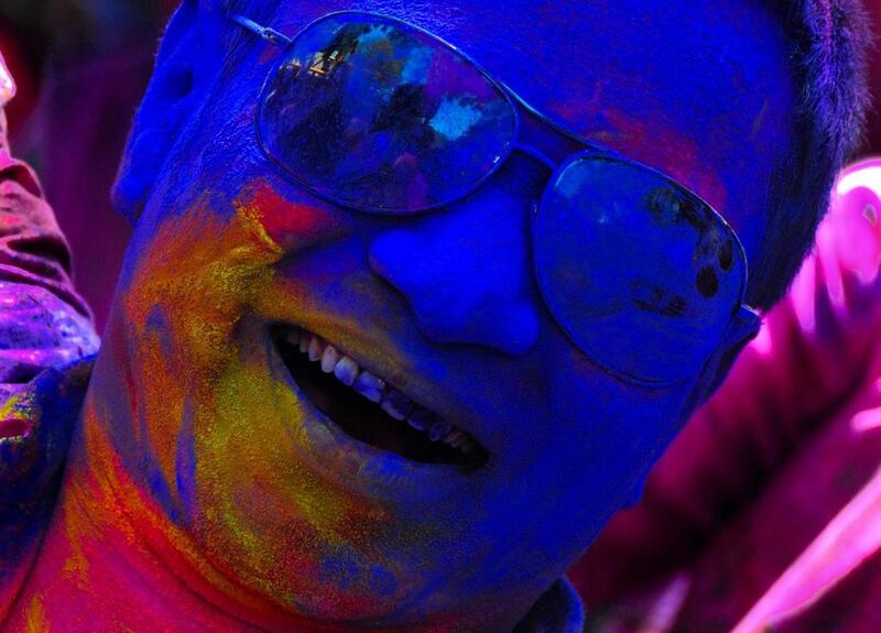 An Indian reveller smeared with colours dances to Bollywood tunes during the Holi Festival in Bangalore. Jagadeesh NV / EPA