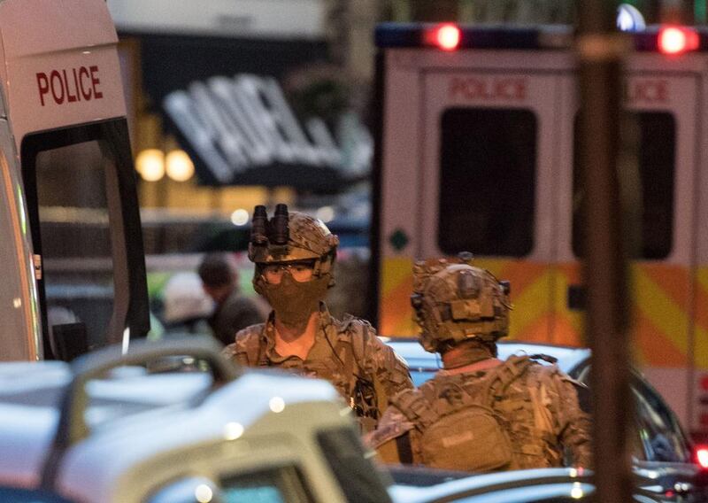 Armed officers are seen on the street outside Borough Market the morning after a terror attack on London Bridge and the Borough area in London. Chris Ratcliffe / AFP