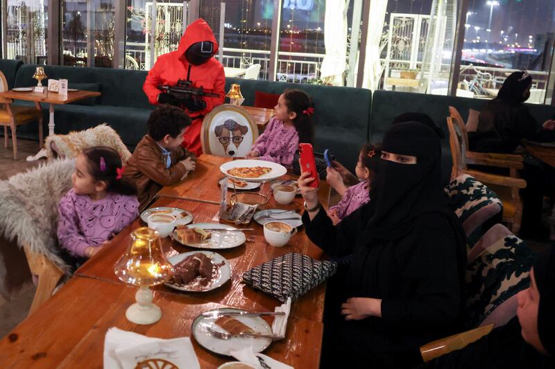 Employees dressed as characters from the series perform to entertain their guests at a restaurant.