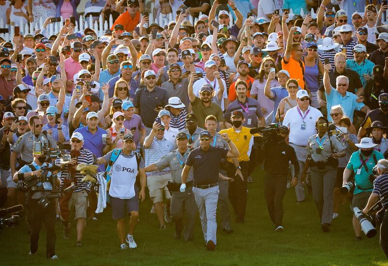 Phil Mickelson and caddie Tim Mickelson walks though the crowd on the 18th hole during the final round of the US PGA Championship at Kiawah Island on Sunday, May 23. Mickelson became became the oldest man to win a major title when he completed a two-stroke victory. Reuters