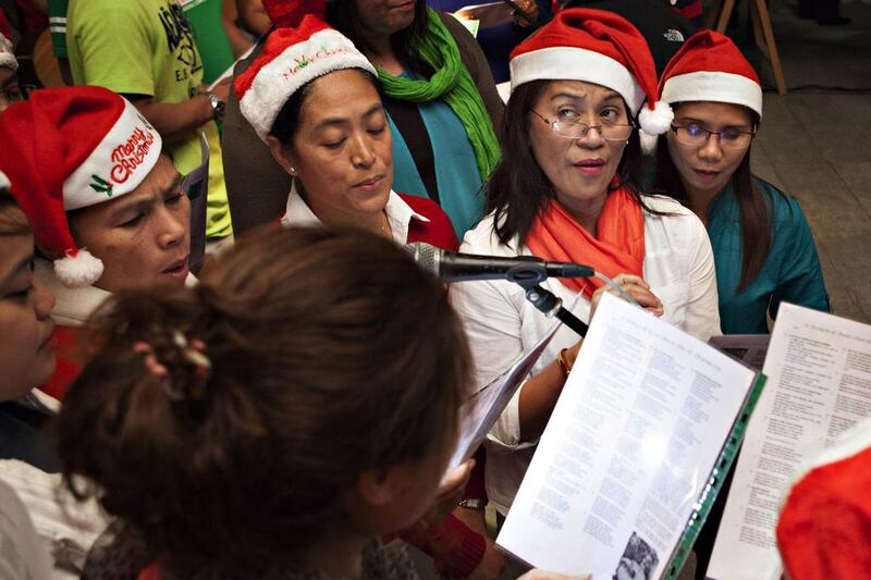 Parishioners of the St Francis of Assisi Catholic Church in Jebel Ali sing Christmas carols. Antonie Robertson / The National