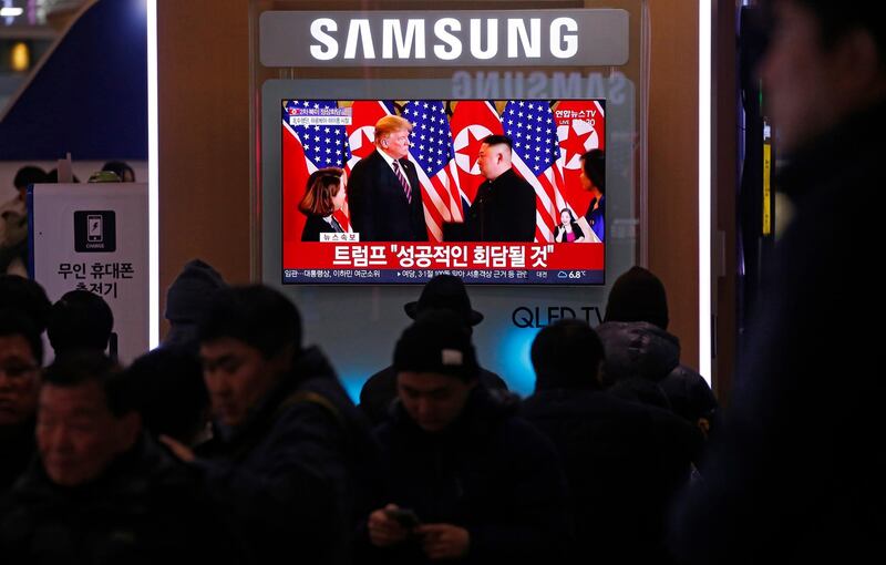 South Koreans watch a TV news broadcast of Donald Trump and Kim Jong-un meeting, in Seoul. EPA