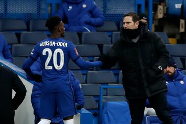 Chelsea's head coach Frank Lampard, right, shakes hands with Chelsea's Callum Hudson-Odoi during the English FA Cup third round soccer match between Chelsea and Morecambe at Stamford Bridge Stadium in London, Sunday, Jan. 10, 2021. (AP Photo/Matt Dunham)