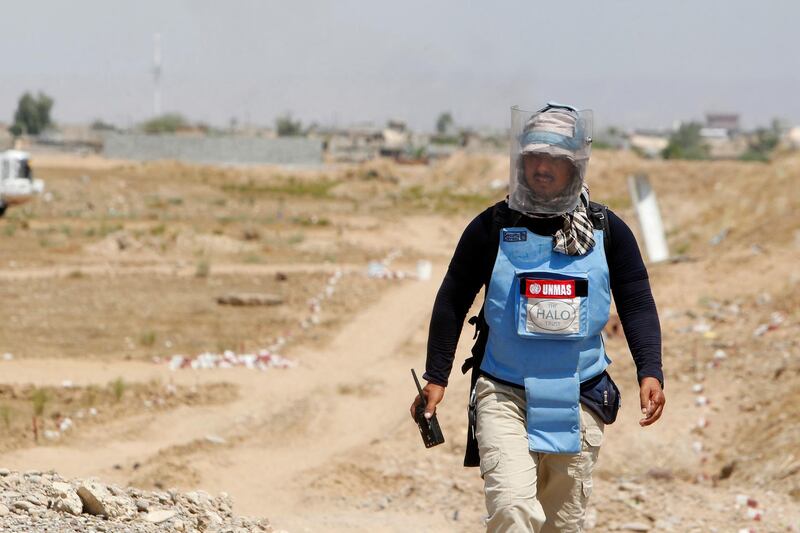 An Iraqi mine clearer working for Halo Trust, a non-profit organisation specialised in mine removal, is pictured in an agricultural and industrial field on August 25, 2019, near the Iraqi town of Baiji, an oil-rich region ravaged by fighting against the Islamic State group (IS) in 2014. - IS planted hundreds of improvised explosive devices as a defencive mechanism in fields around Baiji, which the Halo Trust is still working to remove today. (Photo by SABAH ARAR / AFP)