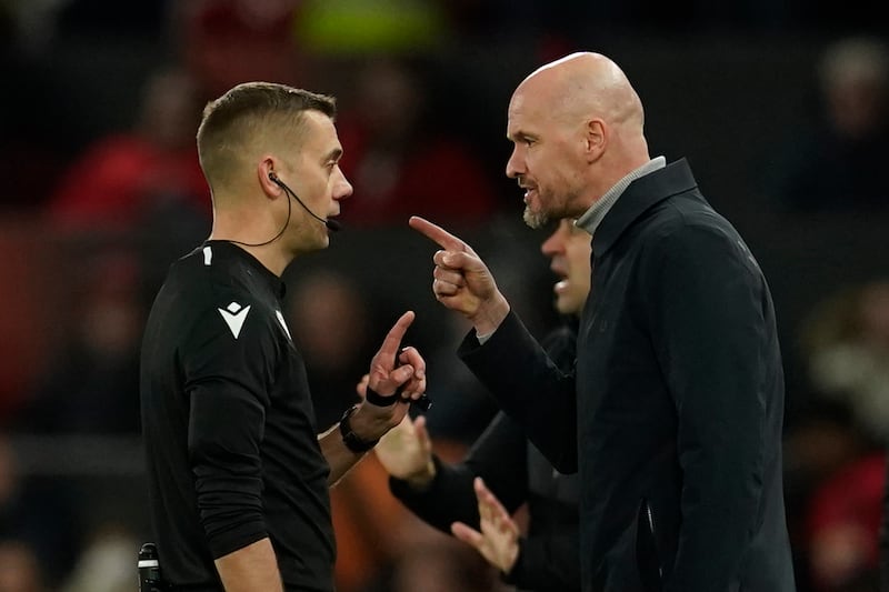 Referee Clement Turpin talks to Manchester United manager Erik ten Hag. AP