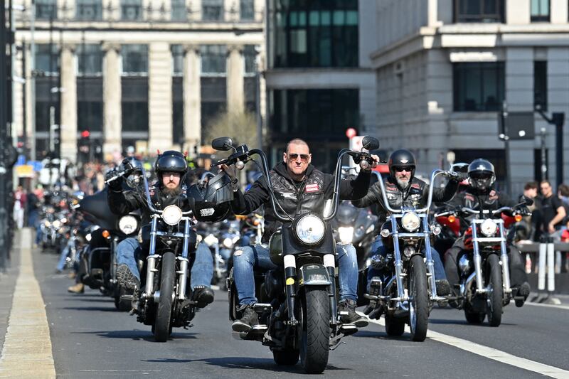 Members ride across London Bridge in March 2022. AFP