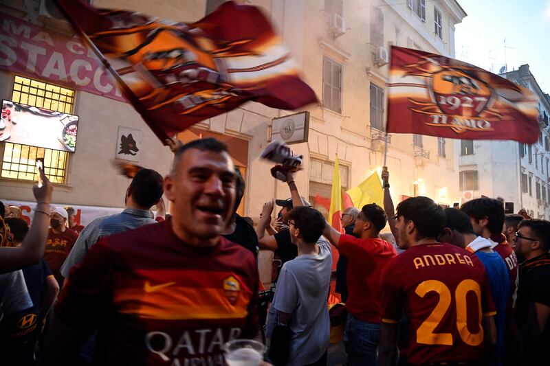 AS Roma fans watch outside the Testaccio Roma Club. EPA