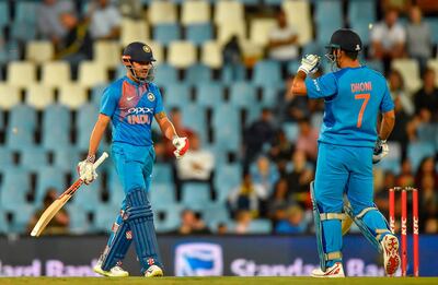 India's Manish Pandey (L) celebrates his half century with India's Dhoni during the second T20I cricket match between South Africa and India at Super Sport Park Stadium in Pretoria on February 21, 2018. / AFP PHOTO / Christiaan Kotze