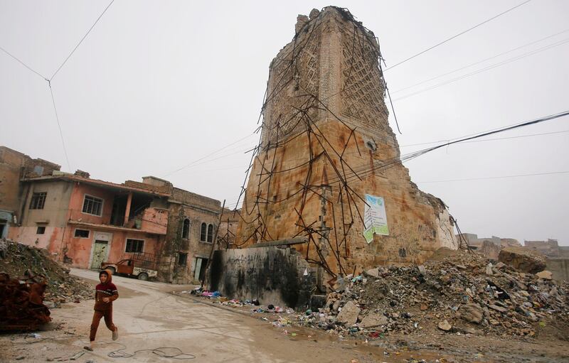 A boy walks near the remains of Mosul's Al-Hadba minaret in the Old City of Mosul, Iraq. Reuters