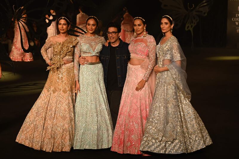 Suneet Varma, centre, poses with models at the end of his fashion show.