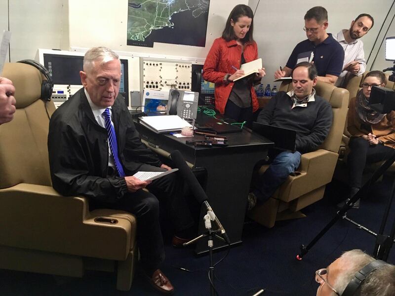 US Secretary for Defense Jim Mattis speaks to reporters aboard a military jet as he travels for a visit to Oman late on March 10, 2018.  / AFP PHOTO / Thomas WATKINS