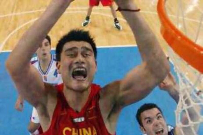 China's Yao Ming goes to the net during play against Serbia and Montenegro in men's basketball at the Athens 2004 Olympics August 23, 2004. Trying to stop Ming is Dejan Tomasevic (R) while Dejan Bodiroga waits for rebound in background. Yao Ming led China to one of the biggest upsets in men's Olympic basketball on Monday, netting 27 points as his team beat Serbia and Montenegro 67-66 to knock the world champions out of the tournament. REUTERS/Lucy Nicholson  AC/CRB
Reuters / Picture supplied by Action Images *** Local Caption *** RBBORH2004082300858.jpg