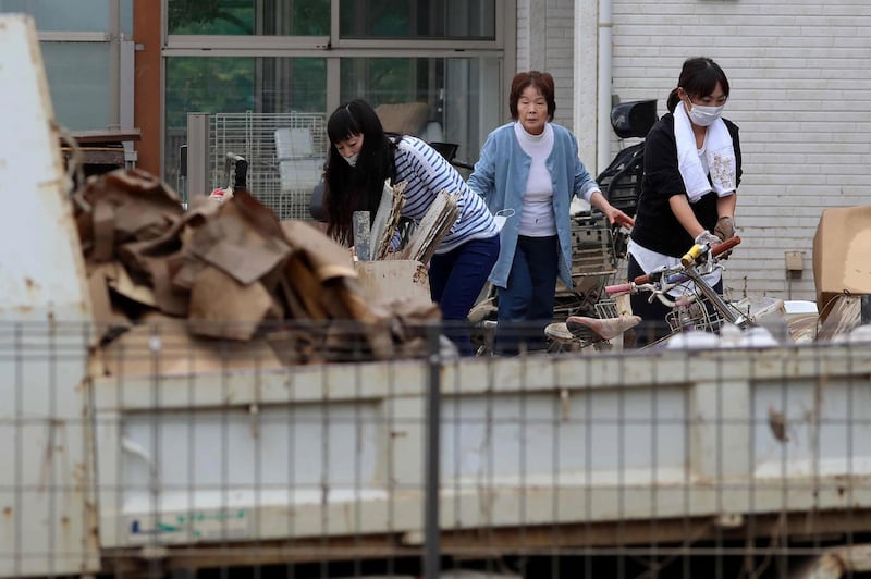 Residents move household items outside their homes in flood-hit area in Kawagoe, Saitama prefecture. AFP