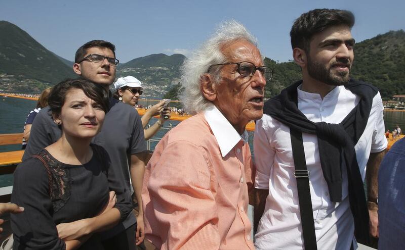 Christo, talks with Khalid Altamini, right, and from left Farah Alkhoury and Mohammed Abu Al Huda, on a boat sailing around his installation at the Iseo Lake. Luca Bruno / AP photo