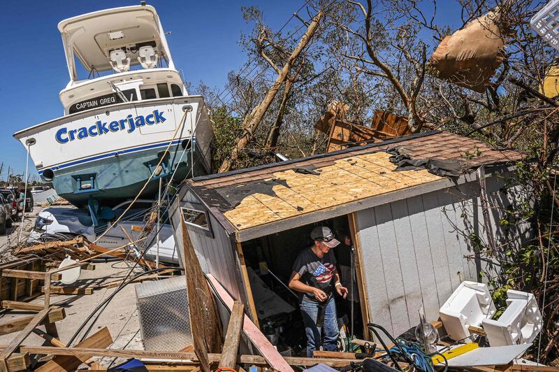 People clear debris in the aftermath of Hurricane Ian in Fort Myers Beach, Florida. AFP