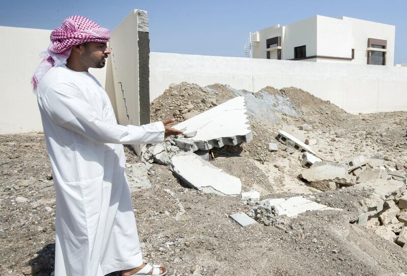 Fujairah, United Arab Emirates - Jasim Al Abdouli showing residence damage by flood at a residential area near Wadi in Al Raheeb Town in Dibba Al Fujairah. Ruel Pableo for The National for Ruba Haza's story