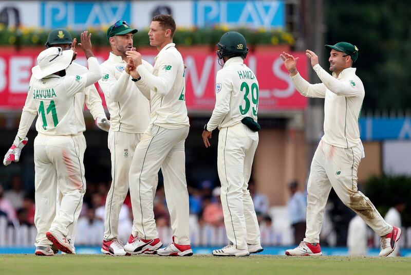 South Africa bowler George Linde celebrates with teammates after dismissing India's Wriddhiman Saha. AP