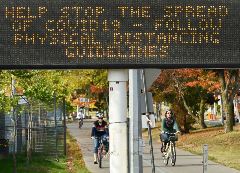 People get exercise along the lakeshore path on Lake Ontario on a fall day during the coronavirus pandemic in Toronto, Tuesday, Sept. 29, 2020. (Nathan Denette/The Canadian Press via AP)