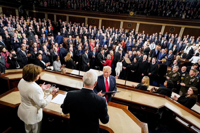 US President Donald Trump, center, looks toward US Vice President Mike Pence, right, and Speaker of the House Nancy Pelosi, a Democrat from California, left, during a State of the Union address to a joint session of Congress at the US Capitol in Washington, DC. Bloomberg