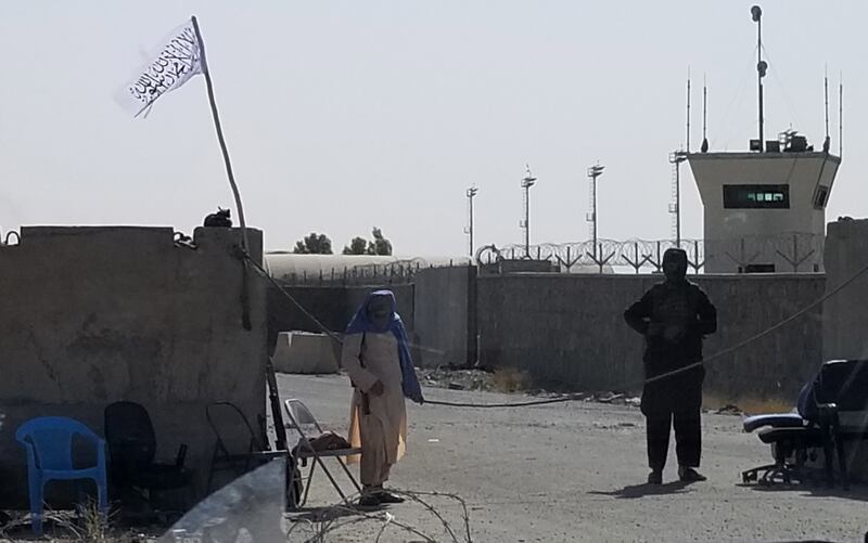 Taliban members stand guard at the main entrance to Kandahar International Airport. EPA