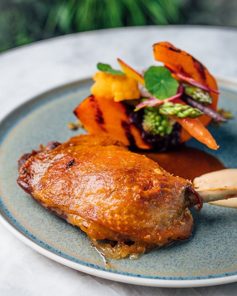 Duck leg confit, pumpkin, baby carrot, orange gastrique from Cyan Brasserie.