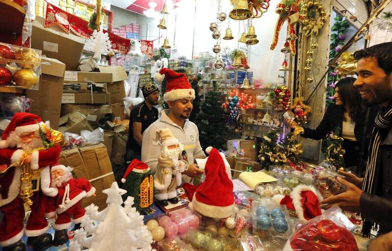 Iraqis shop for Christmas and New Year decorations and gifts at central Baghdad’s Shorjah market. Sabah Arar / AFP / December 20, 2014