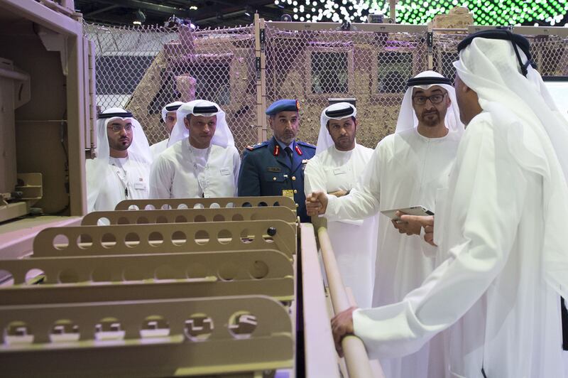 Sheikh Mohammed views a Nimr military vehicle with Saif Al Hajeri Chief Executive Office of Tawazun (3rd R) and Major General Faris Al Mazrouei Chairman of Critical Infrastructure and Coastal Protection Authority (4th R).  Rashed Al Mansoori / Crown Prince Court - Abu Dhabi