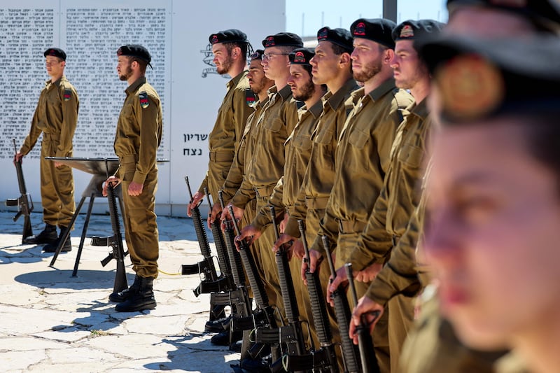 Israeli soldiers observe a two-minute silence in tribute to the fallen soldiers and victims of terrorist attacks at the Armoured Corps Memorial to mark Memorial Day. AFP