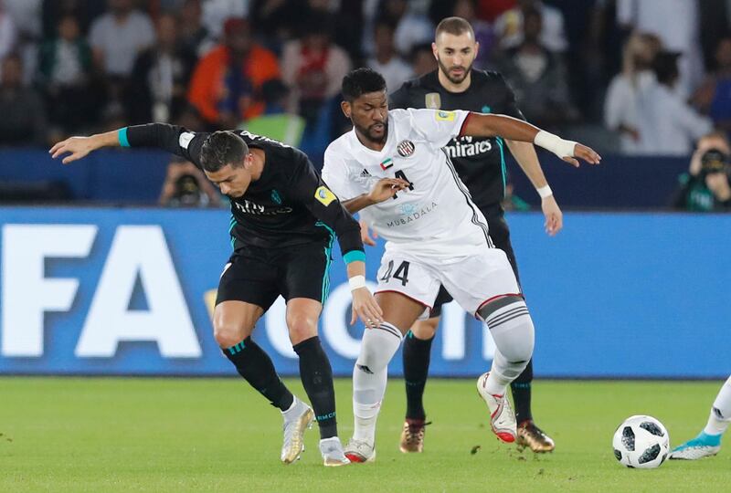 Real Madrid's Cristiano Ronaldo, left, challenges for the ball with Al Jazira's Eissa Mohamed. Hassan Ammar / AP Photo