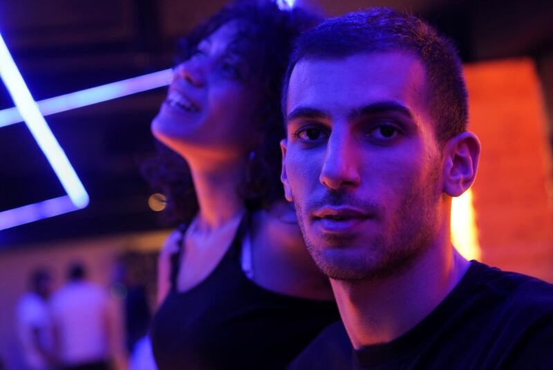 Souna, 25, a business manager, and Karam, 23, a DJ, go bowling with their friends in Damascus, Syria. "I feel like I must either stay this way - careless... or I will go insane," says Karam. Reuters