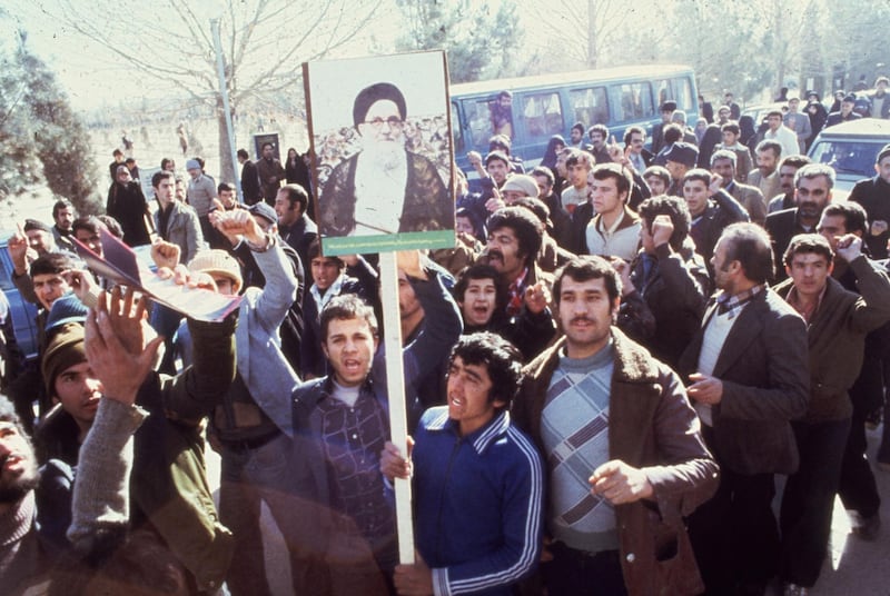 1979:  Demonstrators in Teheran calling for the replacement of the Shah of Iran during the Iranian Revolution. They carry placards depicting Ayatollah Mahmoud Talaghani, one of Iran's most militant religious leaders.  (Photo by Keystone/Getty Images)