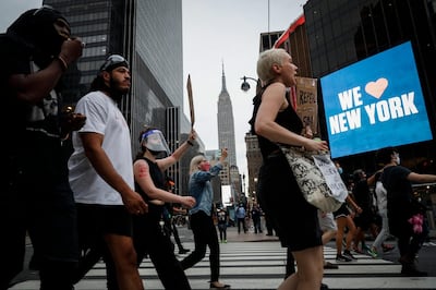 Protesters march past Madison Square Garden as the Empire State Building stands in the background, Thursday, June 4, 2020, in the Manhattan borough of New York. Protests continued following the death of George Floyd, who died after being restrained by Minneapolis police officers on May 25. (AP Photo/John Minchillo)