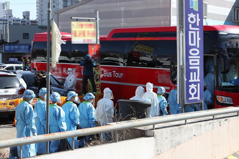 Students in protective gear get on a bus to head to a makeshift clinic at an alternative school in Gwangju, as around 200 students at the school come down with Covid19 while lodging together. EPA
