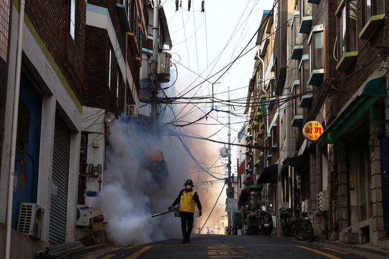 A South Korean disinfects an alley to prevent the spread of the coronavirus in Seoul, South Korea. Getty Images