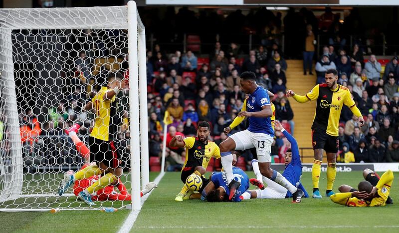 Everton's Yerry Mina pokes home their first goal at Watford. Reuters