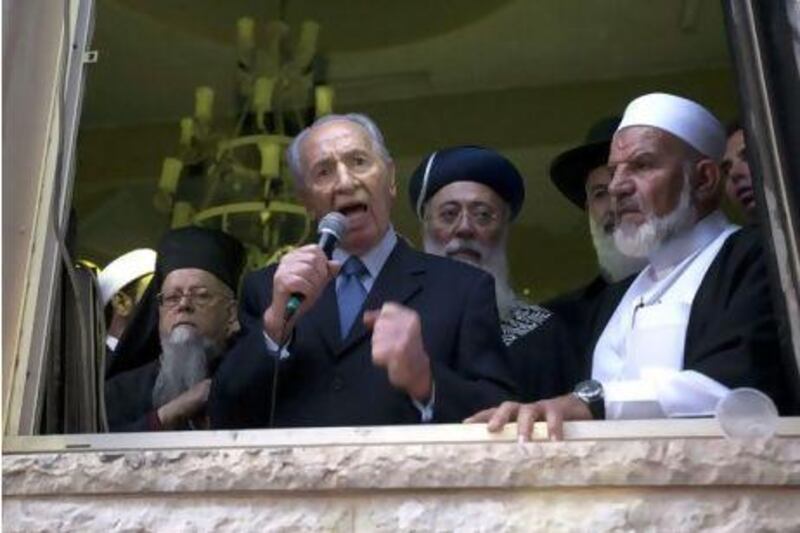 The Israeli president, Shimon Peres (centre), accompanied by Sheikh Mohammed Quwan (right), speaks to residents of the Bedouin village of Tuba Zangaria, in northern Galilee, after inspecting a mosque that was torched overnight yesterday in a suspected revenge attack by right-wing extremists. AFP PHOTO / POOL /MENAHEM KAHANA