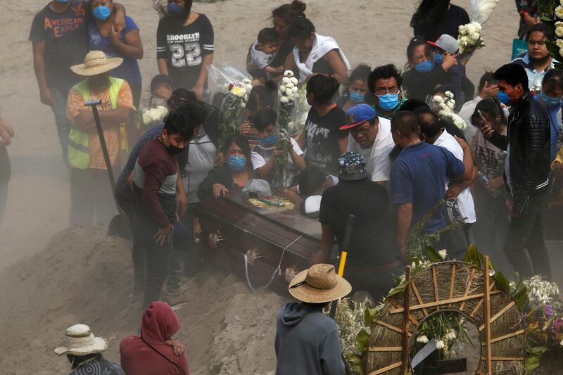 Relatives bury their loved one at the newly constructed Valle de Chalco Municipal Cemetery on the outskirts of Mexico City. AP Photo