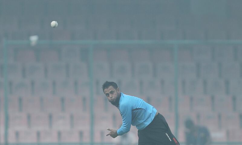 Arafat Sunny bowls amidst smog during a practice session in New Delhi. Reuters
