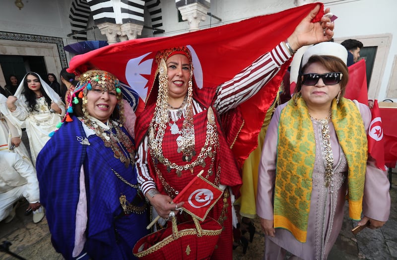 Women fly the Tunisian flag at the festival.