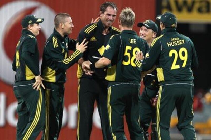 Australia's John Hastings, centre, celebrates with his teammates after getting the wicket of England's Ian Bell.