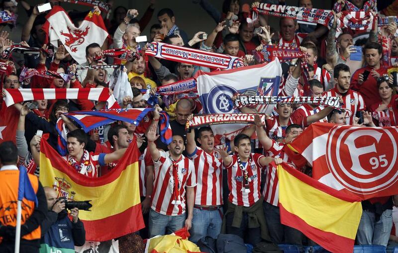 Atletico Madrid fans cheer before the start of the Champions League semi-final second leg football match against Chelsea on Wednesday. Adrian Dennis / AFP / April 30, 2014